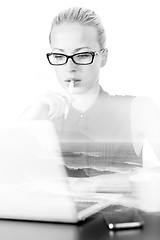 Image showing Business woman working on her laptop computer in office.