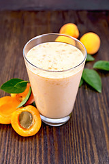 Image showing Milkshake apricot in high glassful on board