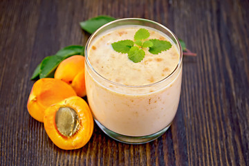 Image showing Milkshake apricot in glassful on board