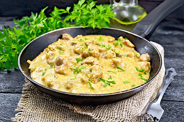 Image showing Meat stewed with cream in pan on burlap