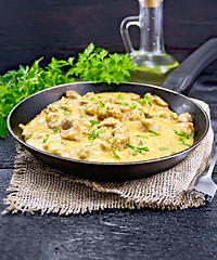 Image showing Meat stewed with cream on black board