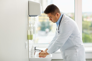 Image showing doctor washing hands at medical clinic sink