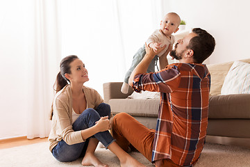 Image showing happy mother and father playing with baby at home