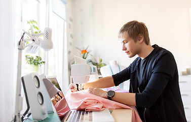 Image showing fashion designer with sewing machine working