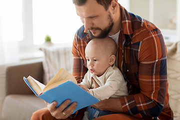 Image showing happy father and little baby boy with book at home