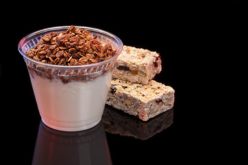 Image showing Yogurt with chocolade granola and granola bar with fruits and nuts