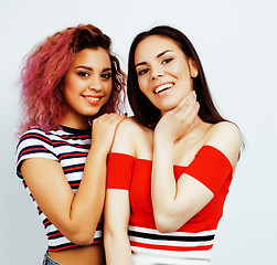 Image showing best friends teenage girls together having fun, posing emotional on white background, besties happy smiling, lifestyle people concept, blond and brunette multi nations 