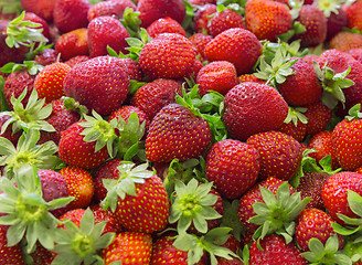 Image showing Background of beautiful and juicy strawberries with green leaves