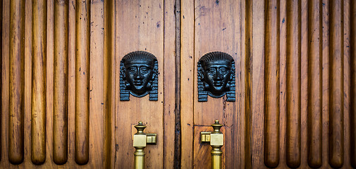 Image showing Sphinx heads entrance on wooden door