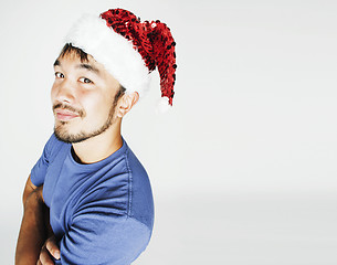 Image showing funy exotical asian Santa claus in new years red hat smiling