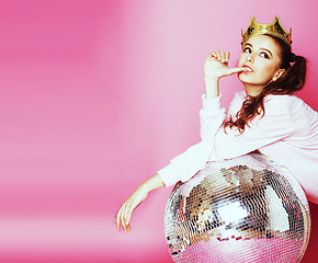 Image showing young cute disco girl on pink background with disco ball and cro