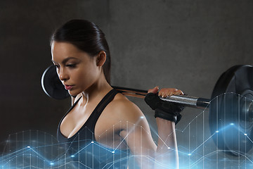 Image showing young woman flexing muscles with barbell in gym