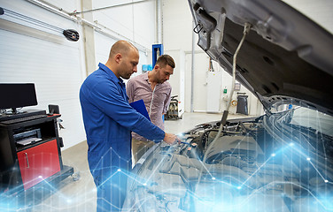 Image showing auto mechanic with clipboard and man at car shop