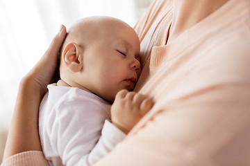 Image showing close up of mother holding sleeping baby