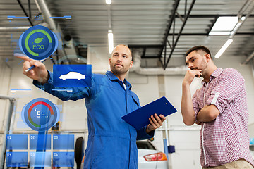 Image showing auto mechanic with clipboard and man at car shop