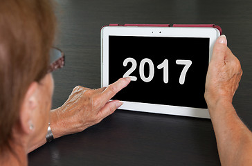 Image showing Senior lady relaxing and her tablet - 2017