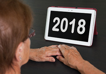 Image showing Senior lady relaxing and her tablet - 2018