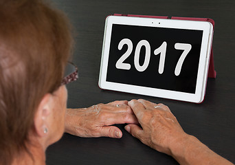 Image showing Senior lady relaxing and her tablet - 2017