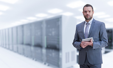 Image showing Young businessman in server room