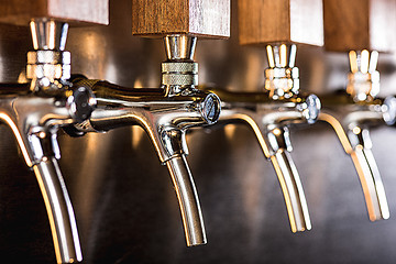 Image showing Beer taps in a pub