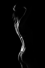 Image showing Black and white silhouette of young, sporty and sexy woman in lingerie