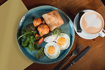 Image showing Scrambled eggs on meat with fried potatoes and toast