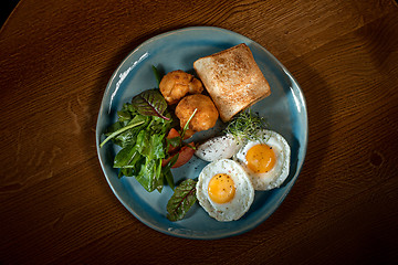 Image showing Scrambled eggs on meat with fried potatoes and toast