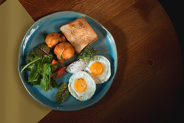 Image showing Scrambled eggs on meat with fried potatoes and toast