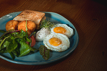 Image showing Scrambled eggs on meat with fried potatoes and toast