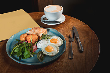 Image showing Scrambled eggs on meat with fried potatoes and toast