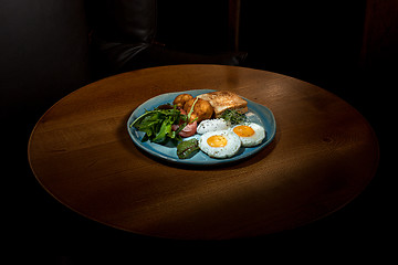 Image showing Scrambled eggs on meat with fried potatoes and toast