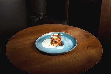 Image showing plate with tasty pancakes on wooden table