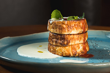 Image showing plate with tasty pancakes on wooden table