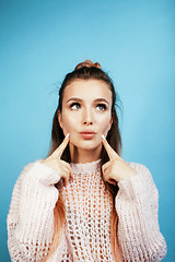 Image showing young pretty woman cheerful happy smiling, posing on blue background, lifestyle people concept