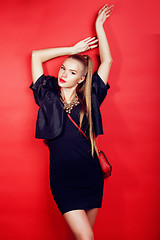 Image showing young pretty woman young lady posing on red background, lifestyle people concept