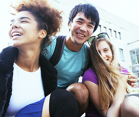 Image showing cute group of teenages at the building of university with books huggings, back to school