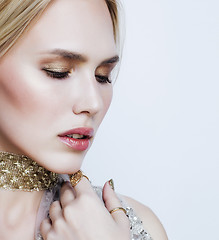 Image showing young pretty blond woman in luxury jewelry, lifestyle rich people concept close up