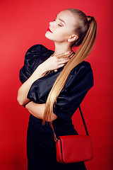 Image showing young pretty woman young lady posing on red background, lifestyle people concept