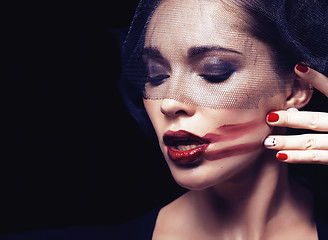 Image showing beauty brunette woman under black veil with red manicure close up