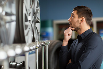 Image showing male customer choosing wheel rims at car service