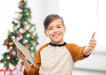 Image showing boy with tablet pc showing thumbs up at christmas