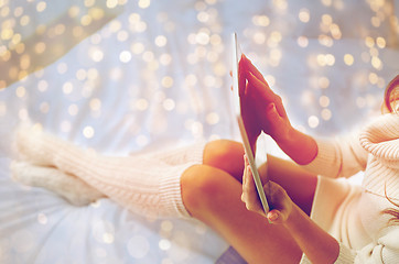 Image showing young woman with tablet pc in bed at home