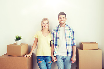 Image showing smiling couple with big boxes moving to new home