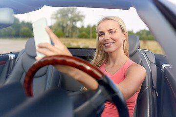 Image showing woman in convertible car taking selfie