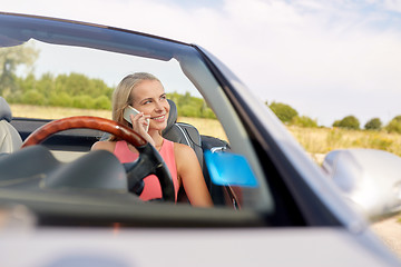 Image showing woman calling on smartphone at convertible car