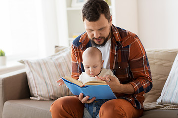 Image showing happy father and little baby boy with book at home