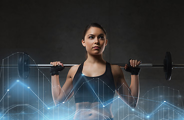 Image showing young woman flexing muscles with barbell in gym