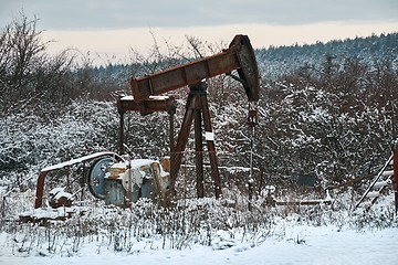 Image showing Oil well on a winter landscape