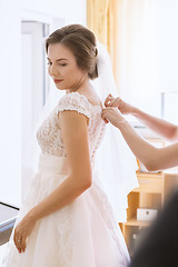 Image showing Beautiful young bride in wedding dress in living room