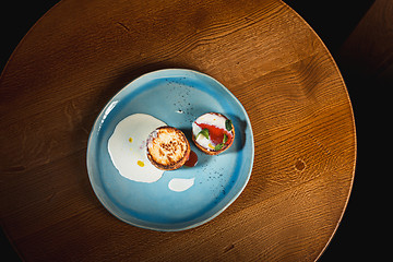 Image showing plate with tasty pancakes on wooden table